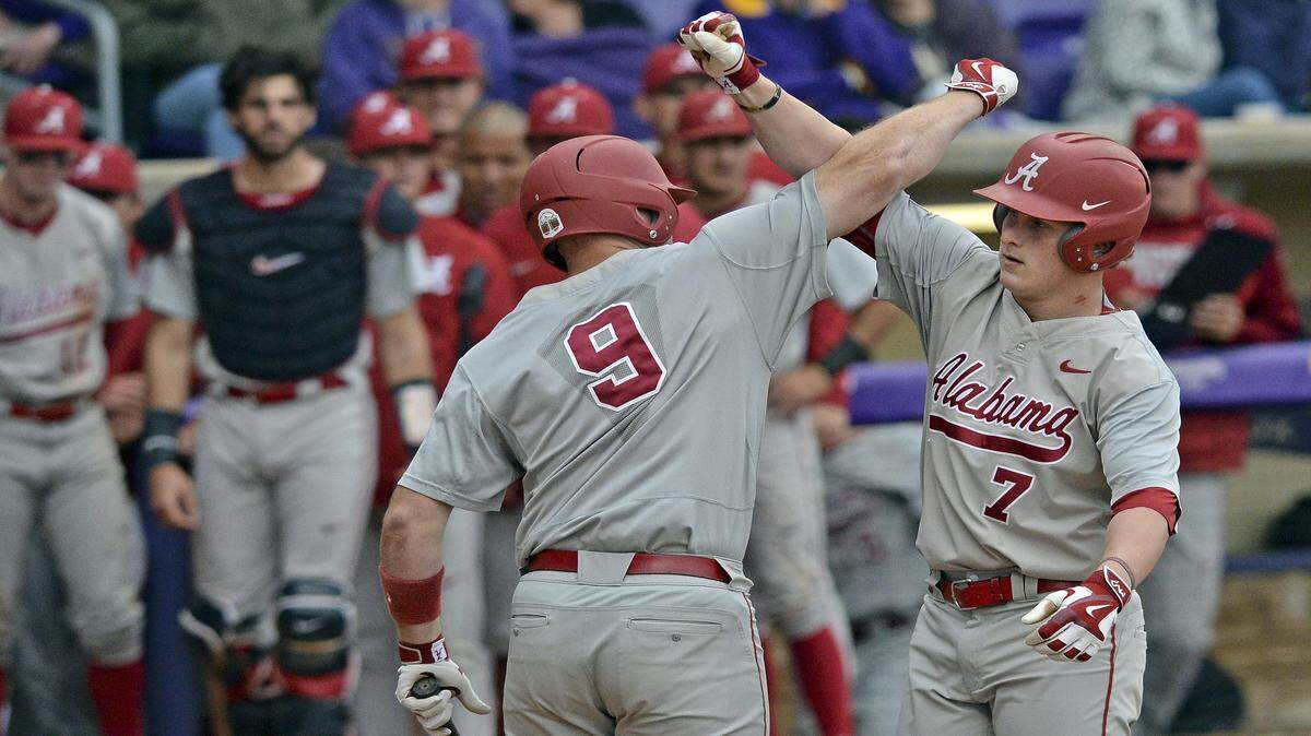 Alabama right fielder Chandler Taylor (7) and Alabama designated hitter Cody Henry (9) celebrate Taylor's two-run home run in the ninth inning of an NCAA college baseball game, Saturday, March 19, 2016, at LSU's Alex Box Stadium, Skip Bertman Field in Baton Rouge, La. (Hilary Scheinuk/The Advocate via AP)