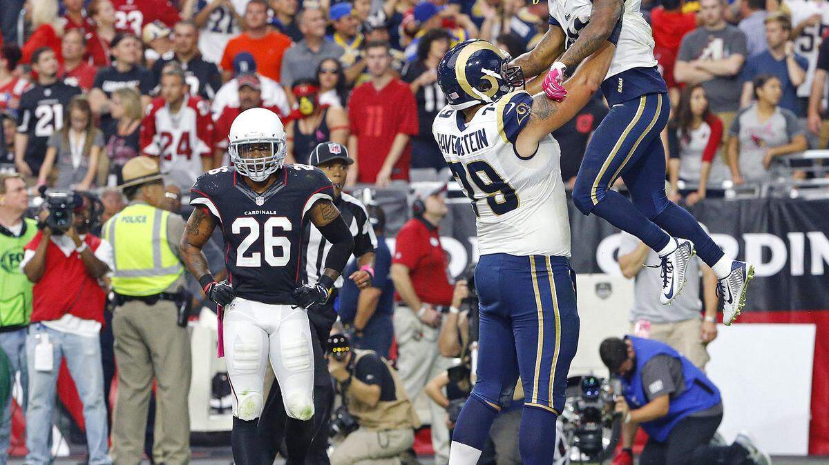 Arizona Cardinals free safety Rashad Johnson (26) reacts as St. Louis Rams offensive tackle Rob Havenstein (79) lifts Tavon Austin into the air following his touchdown during the second half of an NFL football game, Sunday, Oct. 4, 2015, in Glendale, Ariz. (David Kadlubowski/The Arizona Republic via AP) MARICOPA COUNTY OUT; MAGS OUT; NO SALES; MANDATORY CREDIT