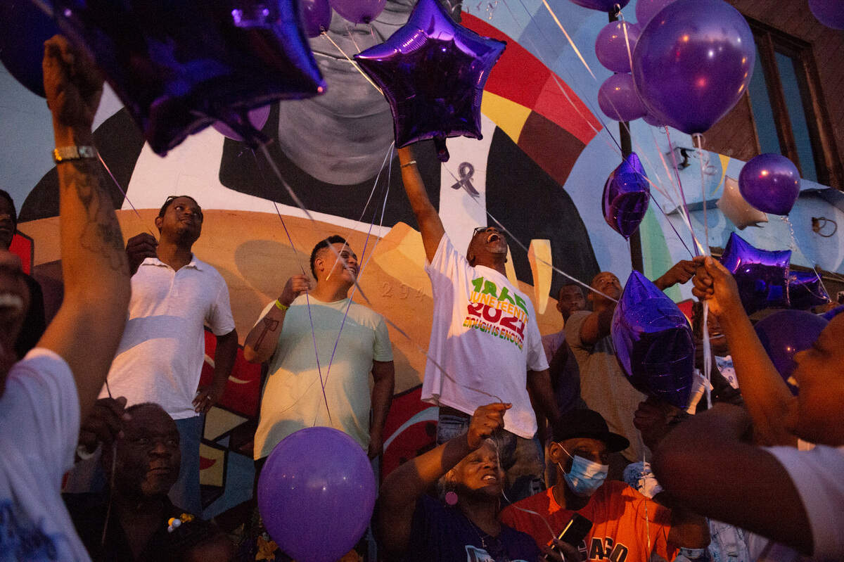 Family and friends of Inez Thomas who gathered outside her restaurant to remember her prepare to let go of purple balloons in her honor in East Biloxi on Friday, Oct. 22, 2021.