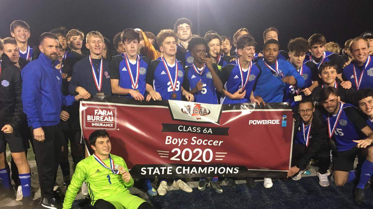 The Ocean Springs boys soccer team celebrates a Class 6A state championship over Madison Central on Saturday in Ridgeland.