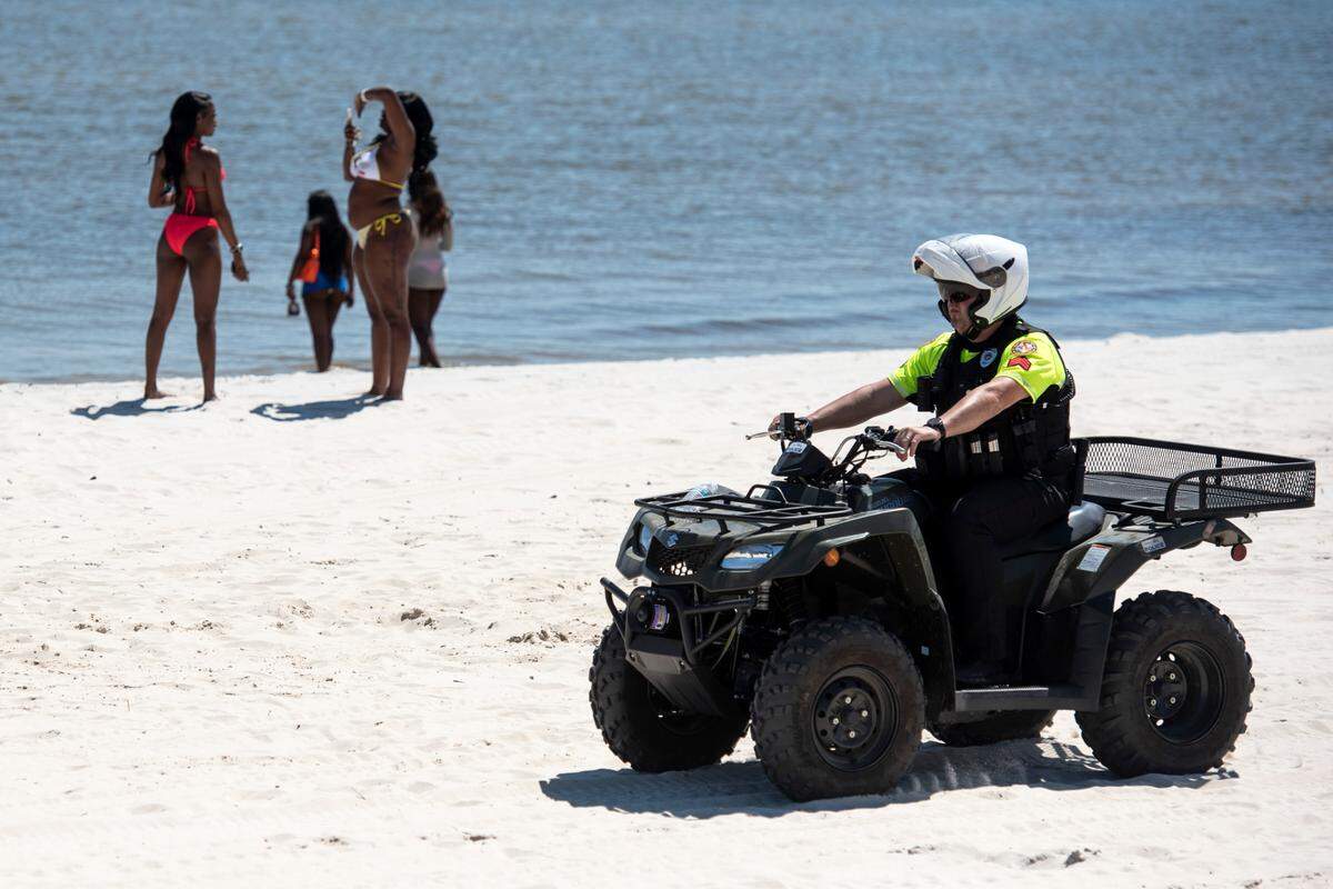 A Biloxi police officer patrols Biloxi Beach during Black Spring Break in 2025.