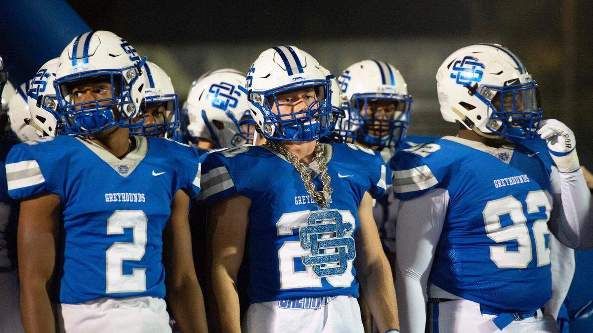 Ocean Springs’ Brady St. Amant wears an Ocean Springs chain before walking onto the field to play Pearl in a playoff game at Greyhound Stadium in Ocean Springs on Friday, Nov. 12, 2021.