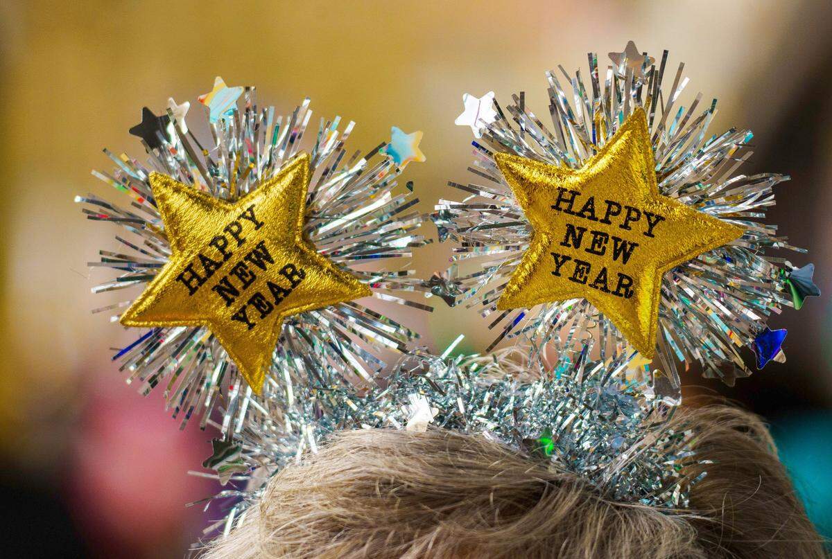 A woman welcomes the new year with a matching headdress with the inscription “Happy New Year.”
