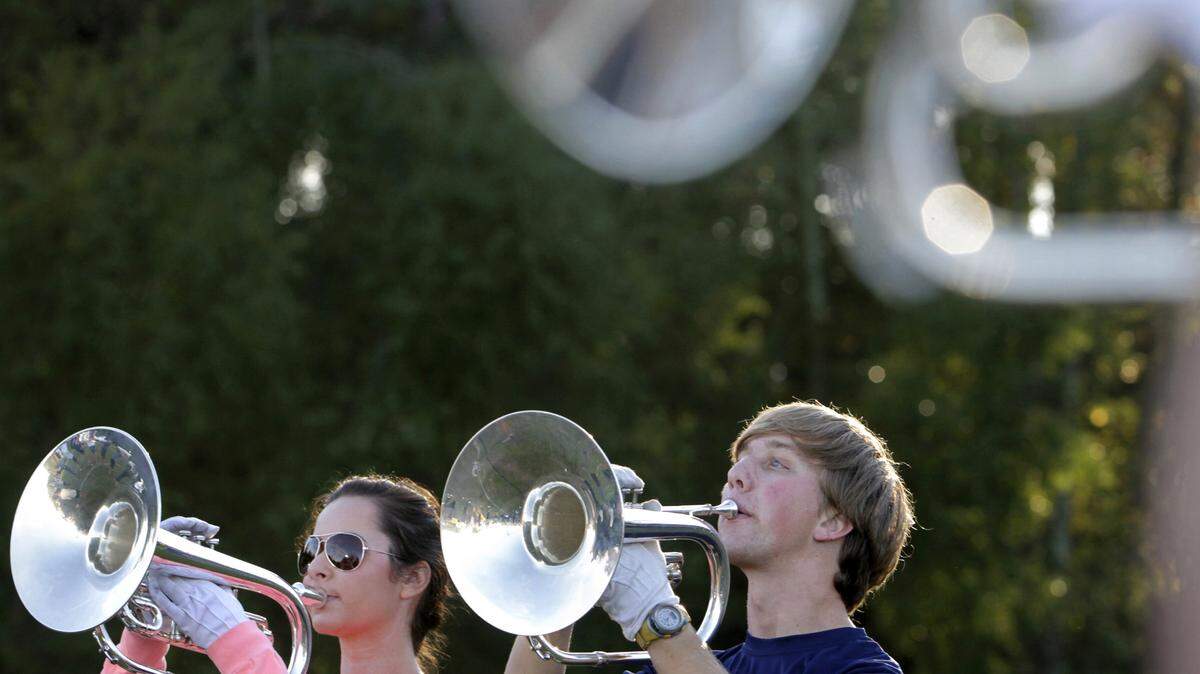ROBIN TRIMARCHI/COLUMBUS LEDGER ENQUIRER 
 Auburn freshman Tripp Gulledge, right, and Hannah Stanfield warm up on the practice field with the mellophone section of the Auburn University Marching Band. Gulledge, who was born with retina problems which has led to almost complete vision loss, often marches during halftime programs. 11.12.15