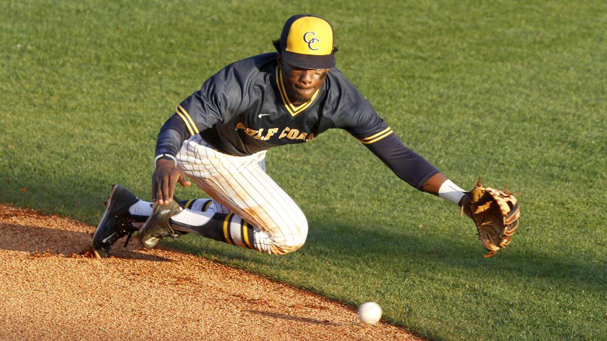 TIM ISBELL/SUN HERALD 
 MGCCC second baseman Marcus Buckley makes a diving attempt at a ground ball against St. Louis Community College, Friday, Feb. 12, 2016.