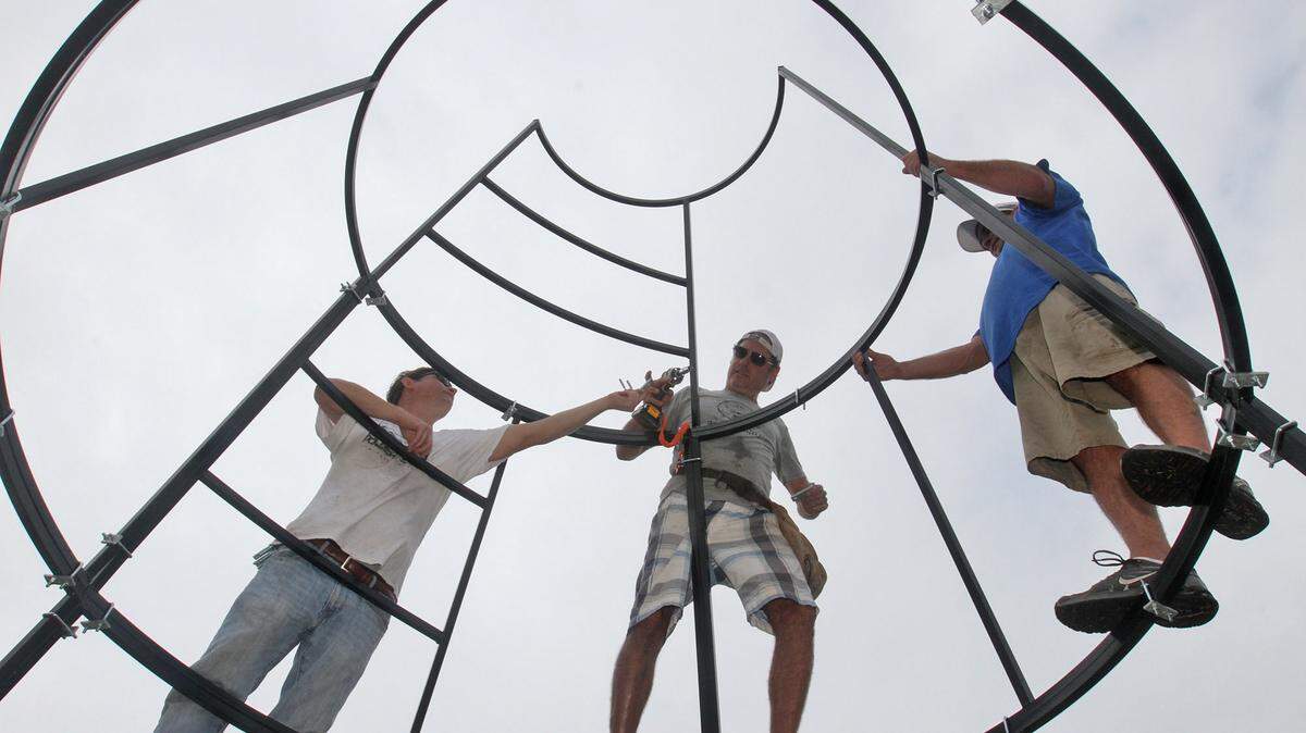 JOHN FITZHUGH/SUN HERALD 
 Universal Concepts workers Sage McReynolds of Ocean Springs, from left, Rudy Veyna of Biloxi and Mike Guild of Blairsville, Ga., build the frame for a Christmas tree in Jones Park in Gulfport on Tuesday Oct. 13, 2015. The tree will be part of an elaborate light show the city is staging.