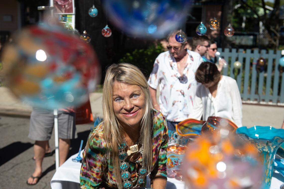 Juli Juneau, a vendor, poses with glass ornaments she’s selling during the Peter Anderson Festival in Ocean Springs on Sunday, Nov. 6, 2022.