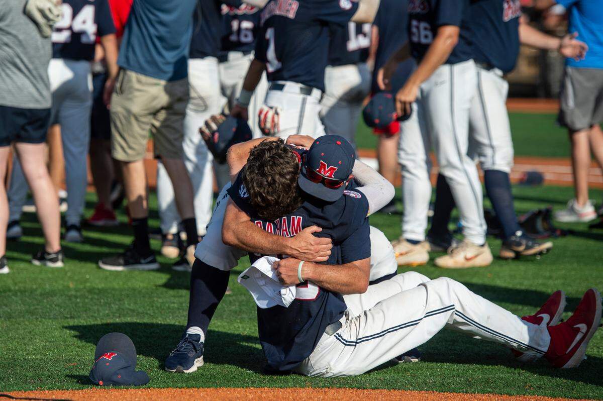 Ole Miss players hug after winning a shot at the College World Series during the Super Regionals Final at Pete Taylor Park in Hattiesburg on Sunday, June 12, 2022.