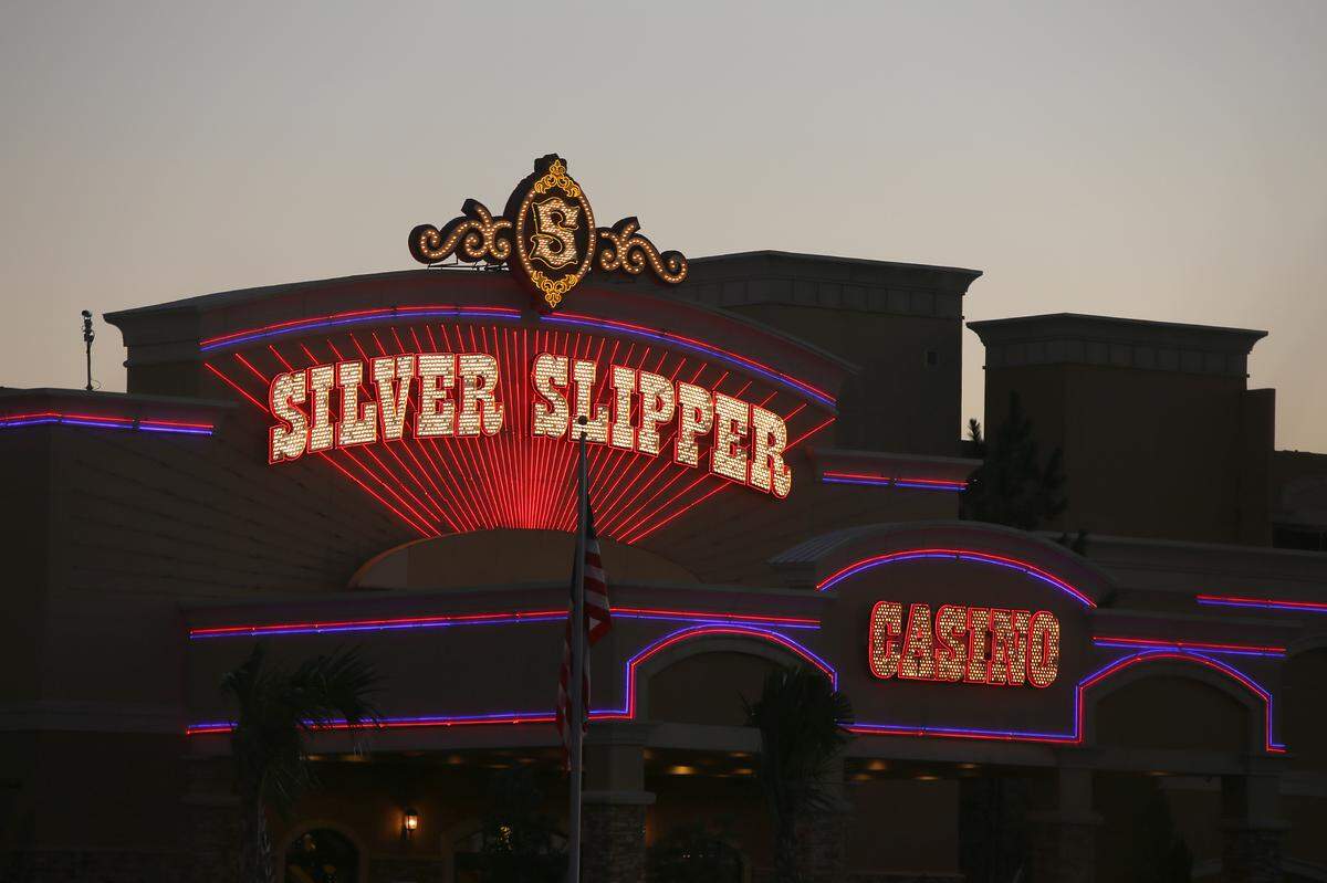 The Silver Slipper Casino’s lights glow as the sun sets on the beach in Waveland on November 4, 2015.