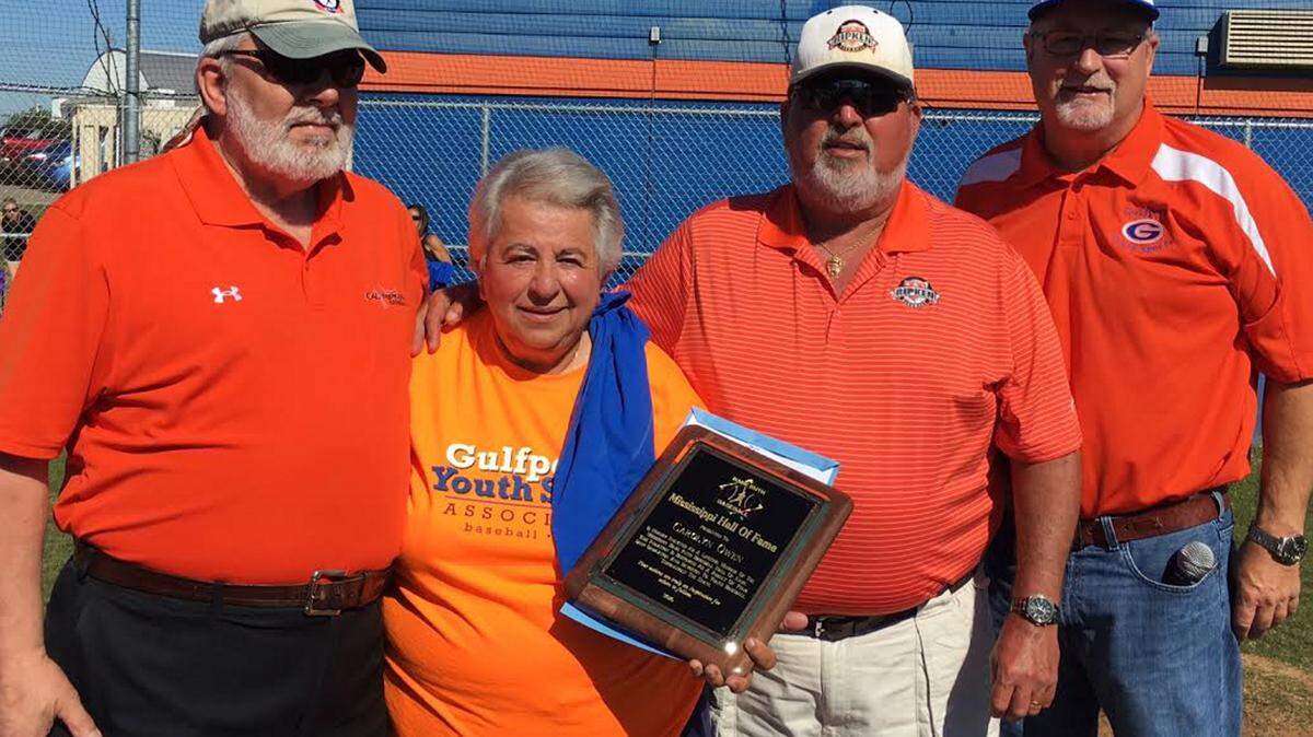 COURTESY SCOTT BARNESHarvey Adams, Babe Ruth Southern District of Mississippi vice president, Pete McGoey, Mississippi District 6 commissioner, and Scott Barnes, past president of Gulfport Youth Sports, induct Carolyn Owen into the Babe Ruth Baseball Hall of Fame.