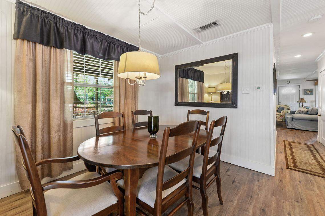 The dining area of Breezy Porches is open and sits beside the kitchen in the Waveland home.