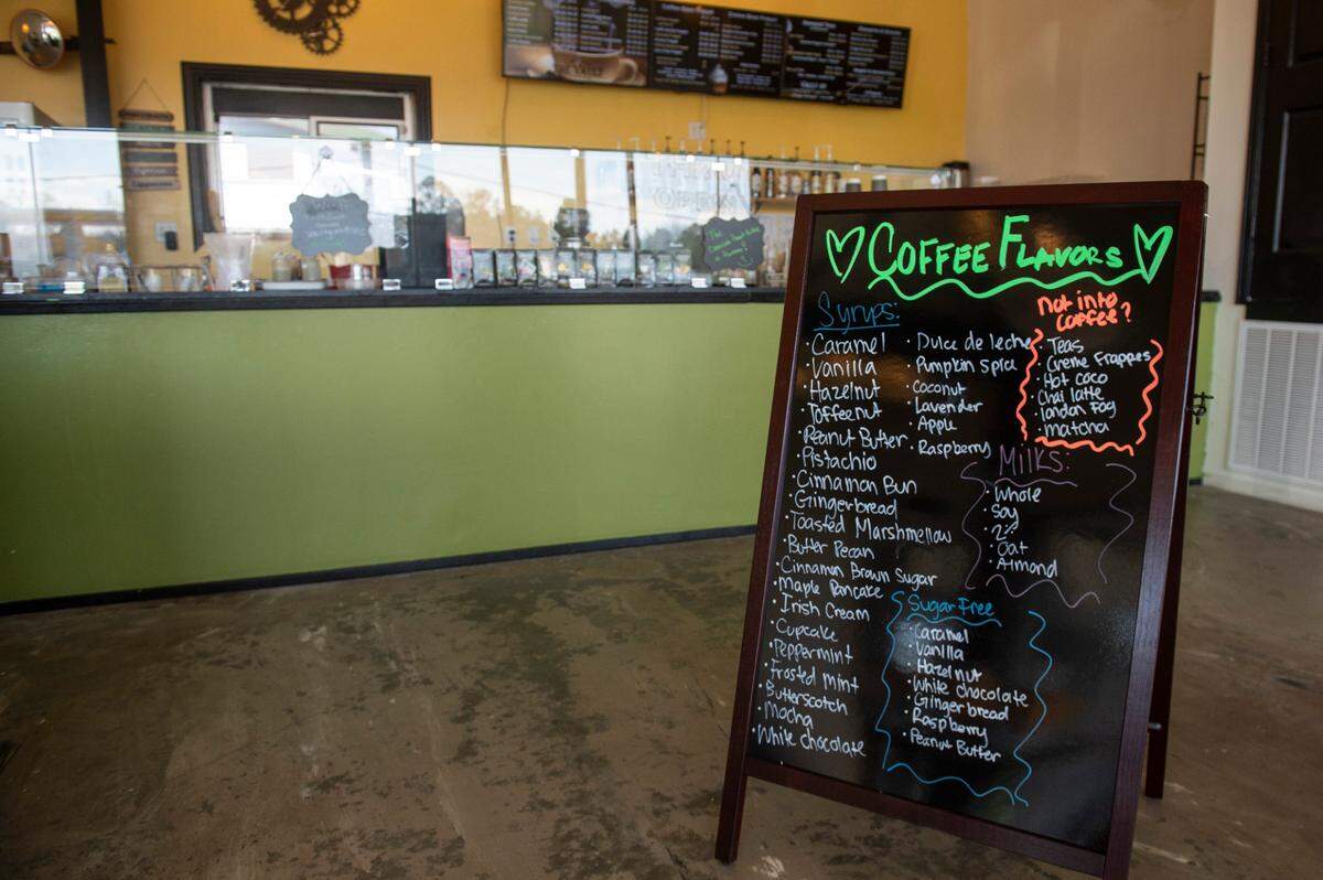 A signboard lists all the coffee flavors available at The Vault Coffee House in Ocean Springs.
