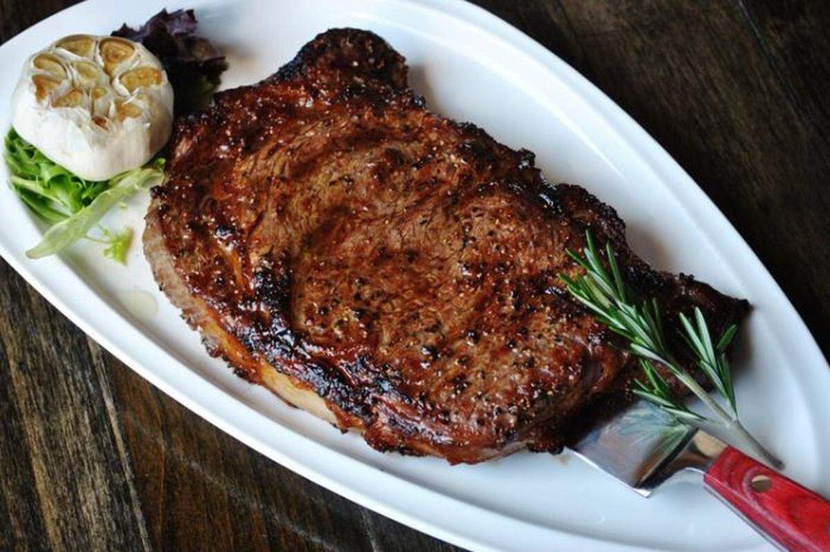 The star of the menu at The Rack House Steaks and Spirits is the selection of steaks that are topped with house-made olive oil and topped with a roasted head of garlic.