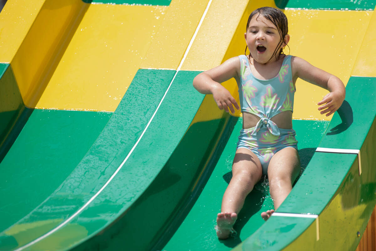 Kids slide down some of the Little Tikes slides at Serengeti Springs at the Hattiesburg Zoo, a new waterpark that opened in May, on Wednesday, June 5, 2024.