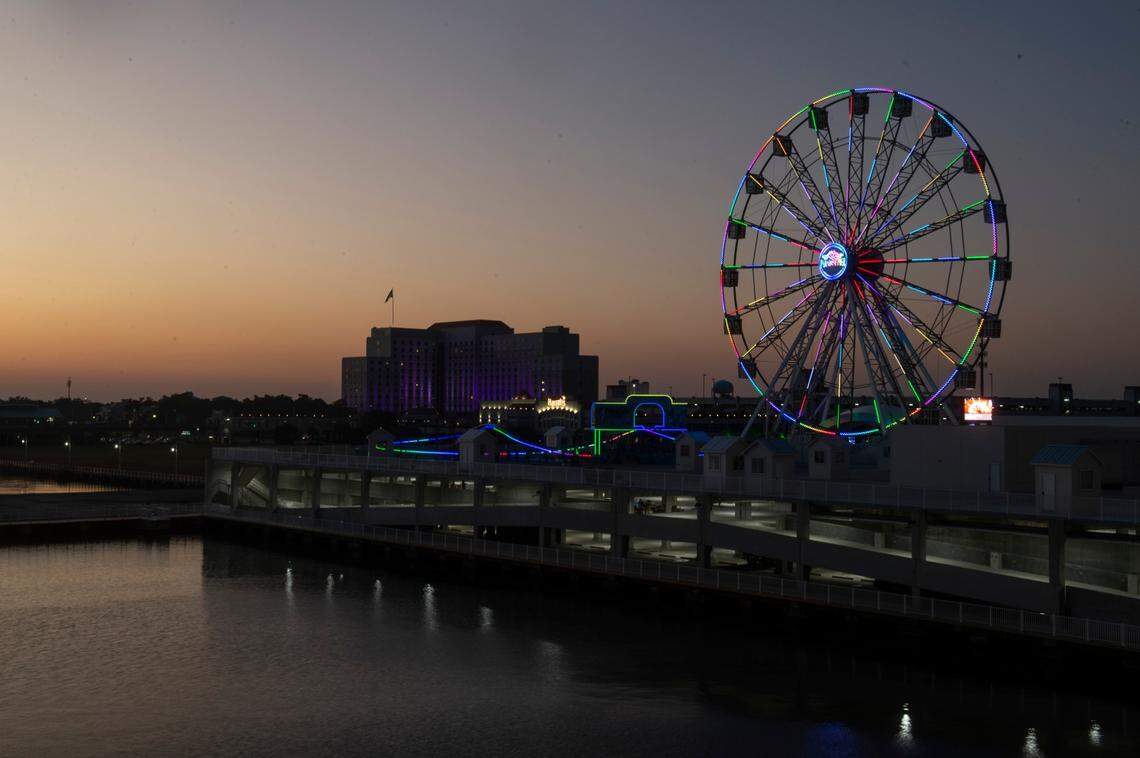 The Ferris wheel at Margaritaville’s Paradise Pier adds some light to the Biloxi skyline at sunset.