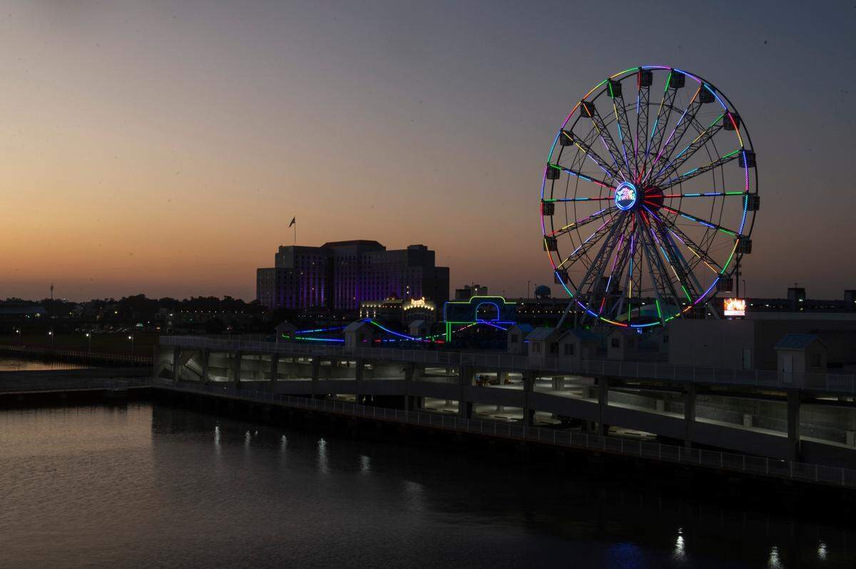 The Ferris wheel at Margaritaville’s new Paradise Pier adds some light to the Biloxi skyline on Thursday, Oct. 13, 2022