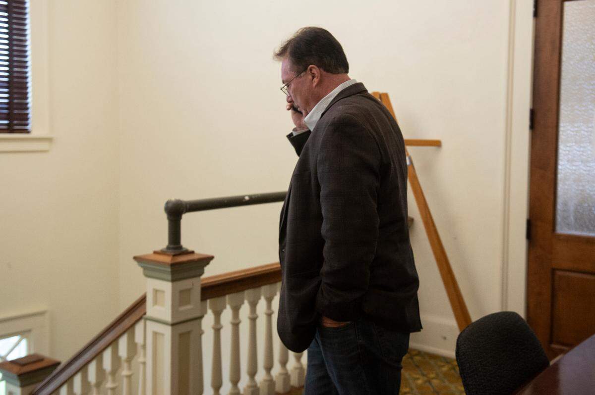 Former State Sen. Philip Moran talks on the phone following his son Alan Moran’s sentencing in Bay St. Louis on Feb. 16, 2024.