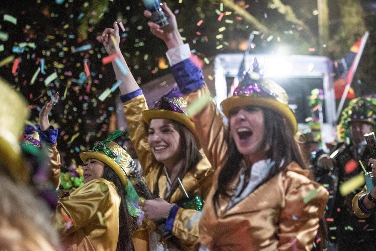 The Ole Biloxi Marching Club sets off confetti poppers during the Ocean Springs Carnival Association Night Parade in Ocean Springs on Friday, Feb. 25, 2022.