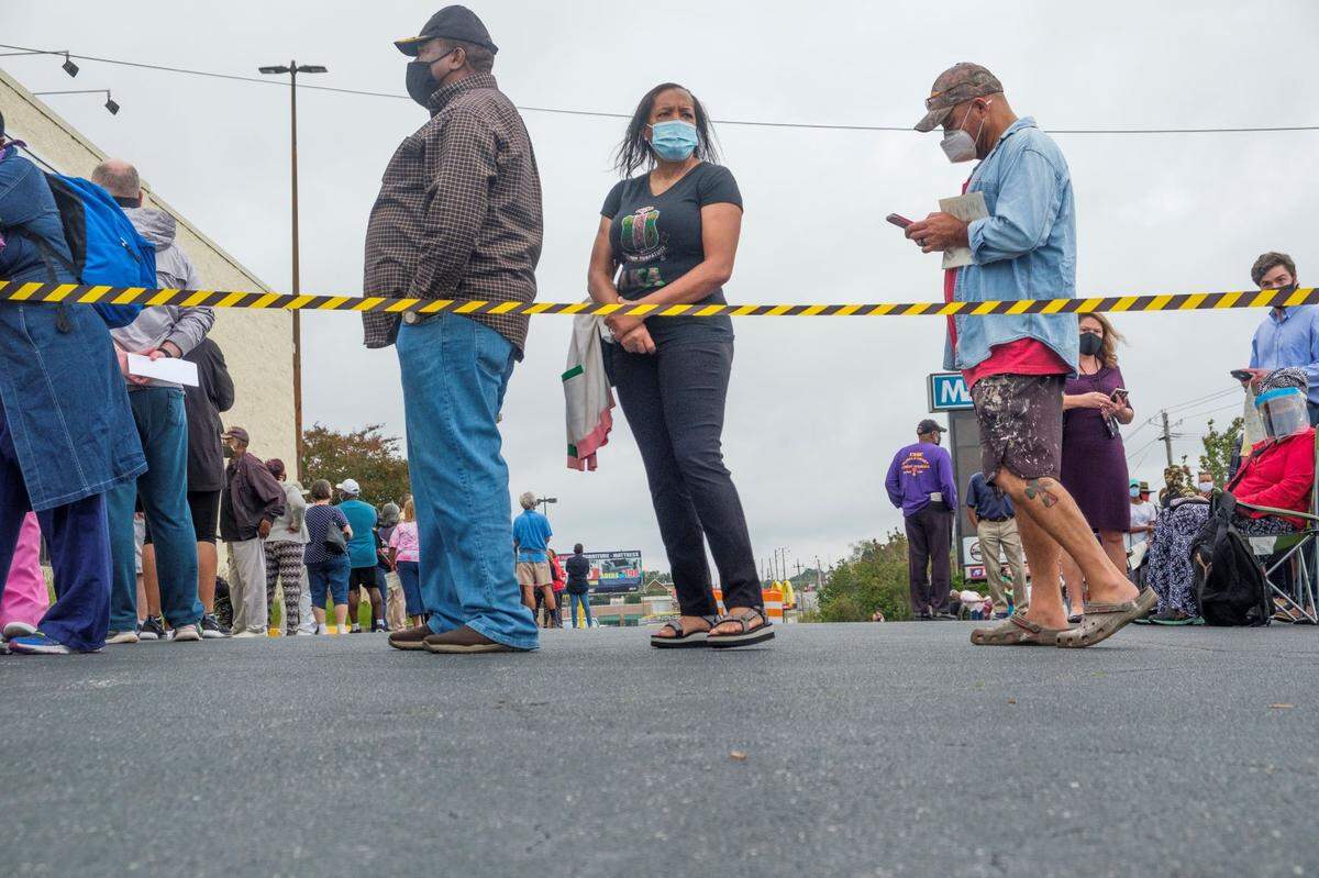The first day of early in-person voting in Georgia is rife reports of hours-long wait times as voters head to their local precincts to cast their ballots.