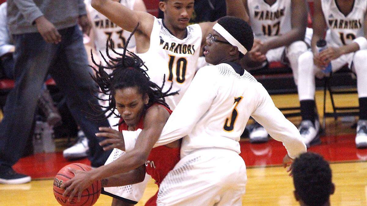 TIM ISBELL/SUN HERALD 
 Jonathan Biscuit Floyd is double teamed by D'Iberville's T. J. Galloway and Jay Jasper, Friday, Dec. 18, 2015.