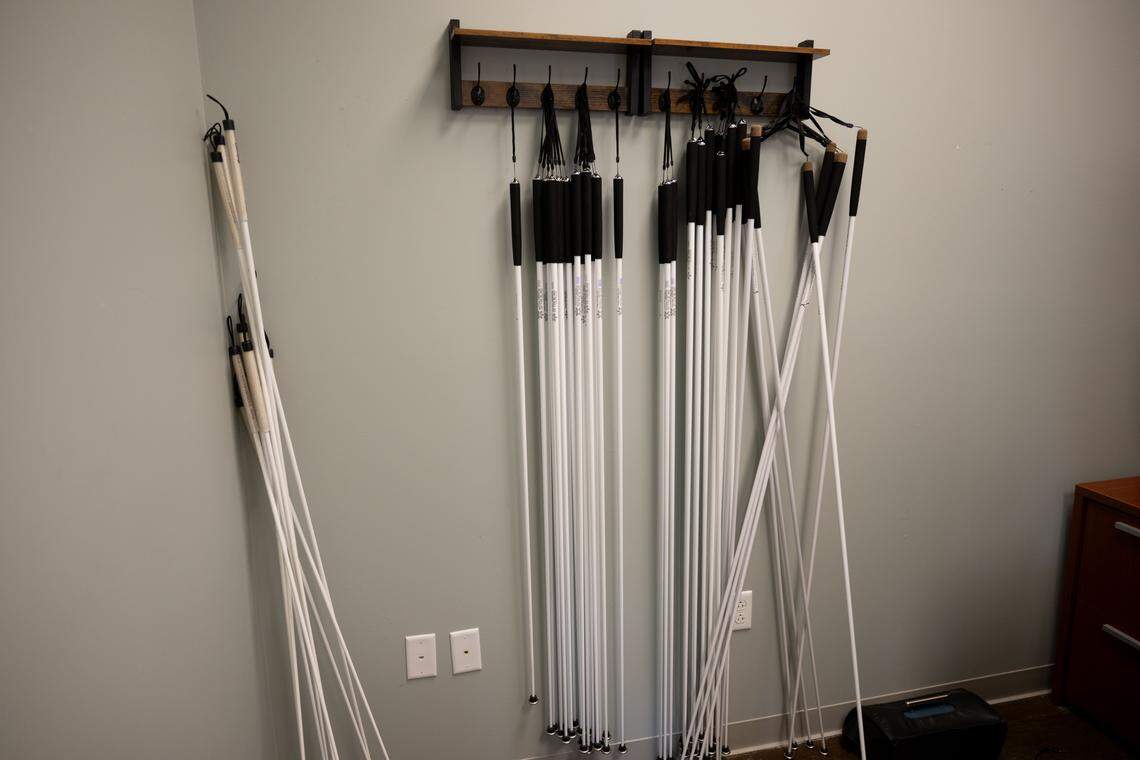 A rack of white walking canes at the Mississippi EMERGE Center in Long Beach on Tuesday, April 21, 2026.