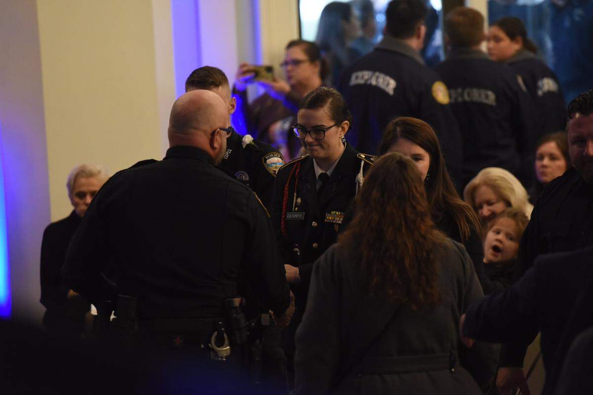 Law enforcement pays respect to a family member of Bay St. Louis Officer Branden Estorffe at a joint funeral service for he and Sgt. Steven Robin on Dec. 21, 2022.