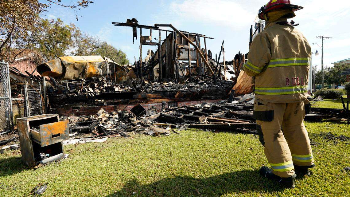 A fireman observes the remains of a burned Epiphany Lutheran Church near midtown Jackson, Miss., Tuesday, Nov. 8, 2022. Authorities in Mississippi’s capital city arrested a man accused of setting several fires early Tuesday morning on and near the campus of Jackson State University, a historically Black public university. At least two of the buildings set ablaze were churches.