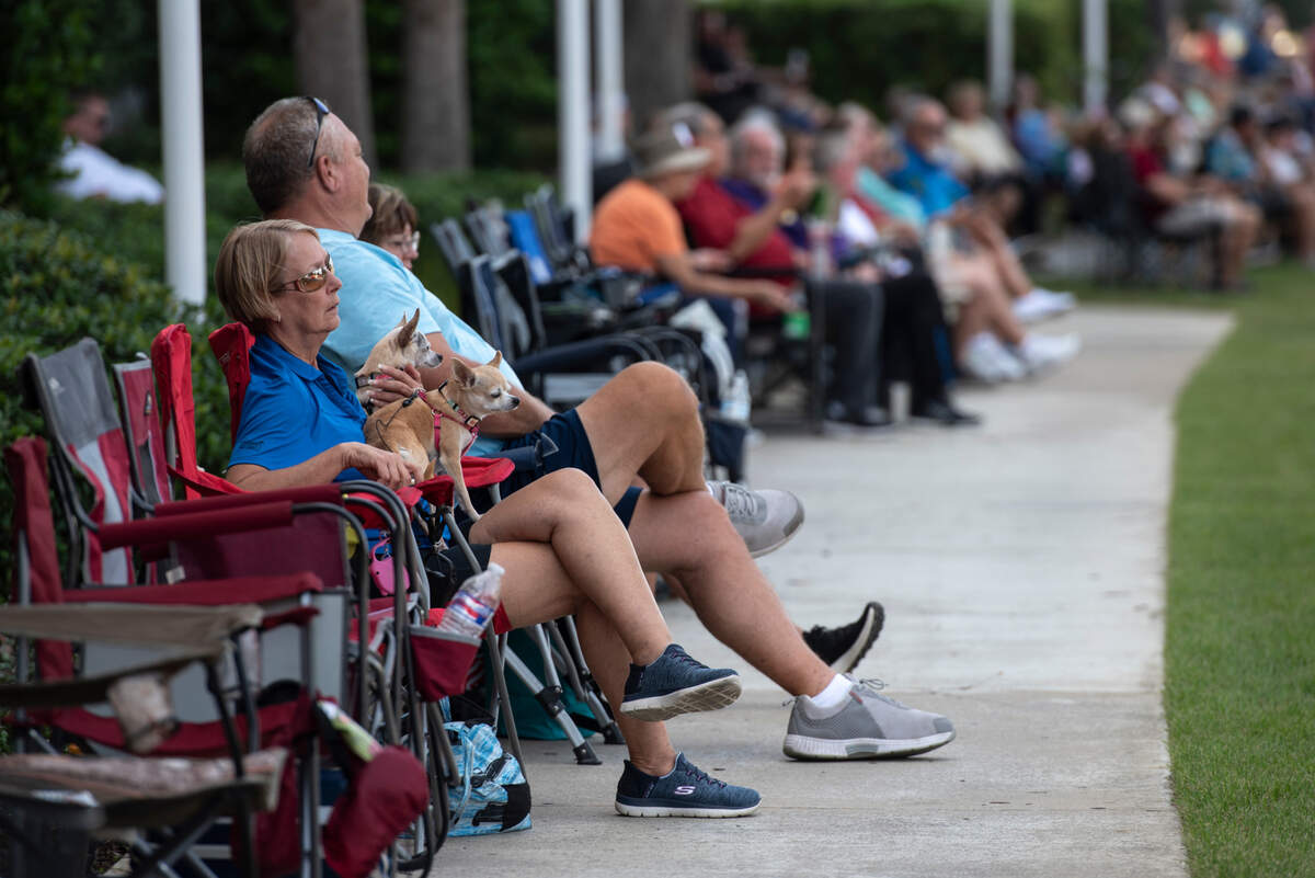 Spectators sit along Highway 90 in downtown Biloxi watching classic cars drive by during Cruisin’ the Coast on Wednesday, Oct. 4, 2023.