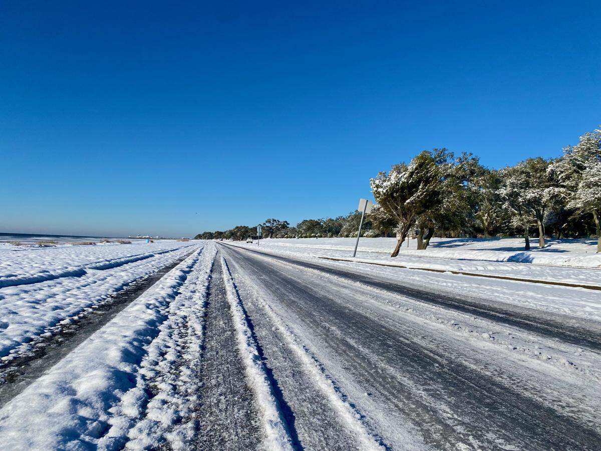 Snow and ice remained Wednesday morning on U.S. 90 in Harrison County after a night of below-freezing temperatures. State and county road crews are salting bridges and roads, but residents are advised to travel only in emergencies until Thursday. This photograph shows the highway in Pass Christian.