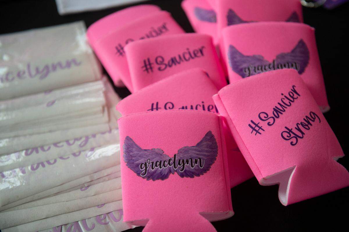 Coozies and stickers memorializing Gracelynn Vick were provided by Inspiration Innovation Print Shop at a candlelight vigil in her honor at Saucier Park on Tuesday, April 22, 2025.