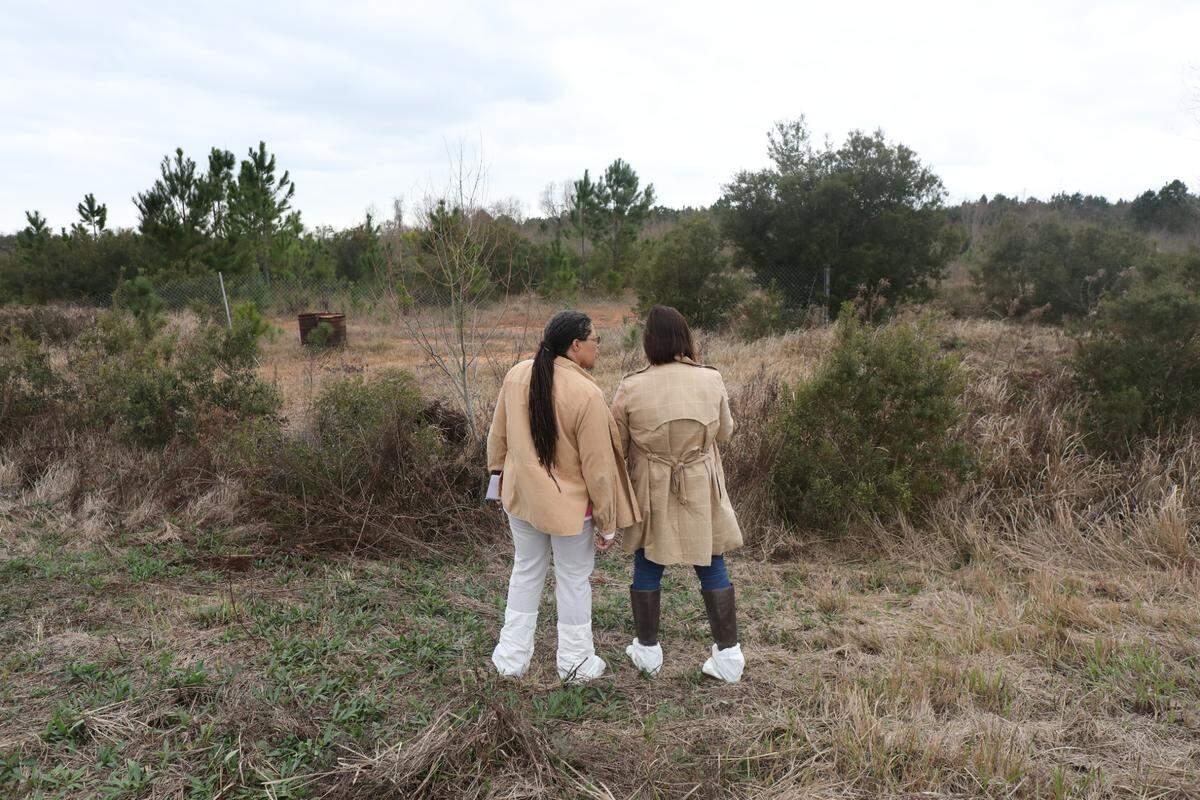 Earthea Nance, left, a civil engineer who specializes in environmental engineering, and attorney Desiree Hensley survey North Gulfport property where the Mississippi State Port Authority wants to build a Department of Defense storage and transfer yard. Project opponents, who toured the property in pre-coronavirus days, fear lead and arsenic on the property will contaminate drainage ditches and waterways, but the state says the contaminants are safely contained.