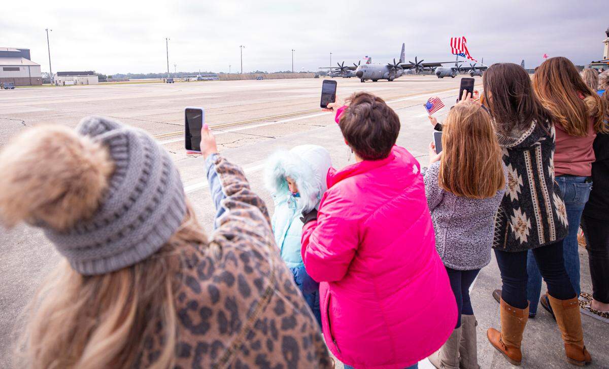 Family members cheer as the reserve citizen airmen return to Keesler Air Force Base in Biloxi, Mississippi, Saturday, Feb. 13, 2021. The airmen from the 815th Airlift Squadron and maintenance and support personnel from throughout the 403rd Wing were deployed to Southwest Asia in October 2020. 