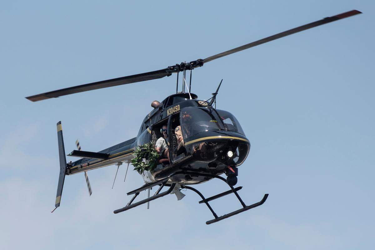 A helicopter from the Harrison County Sheriff’s Department drops a wreath into the ocean during the Blessing of the Fleet in Biloxi on Sunday, May 28, 2023.