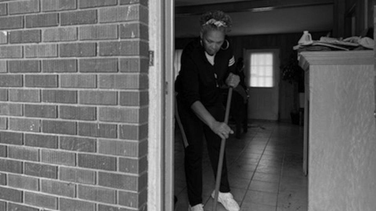 Lois Tops mops blood off the floor of a home on David Street in Gulfport, where her great niece was stabbed and police shot her attacker around 1:40 a.m. Thursday, Feb. 11, 2021.