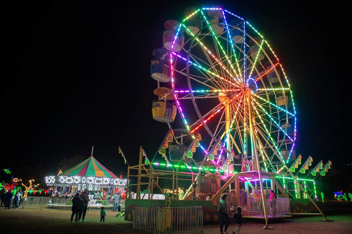 The merry-go-round and Ferris wheel during the Harbor Lights Winter Festival at Jones Park in Gulfport on Thursday, Dec. 2, 2021.