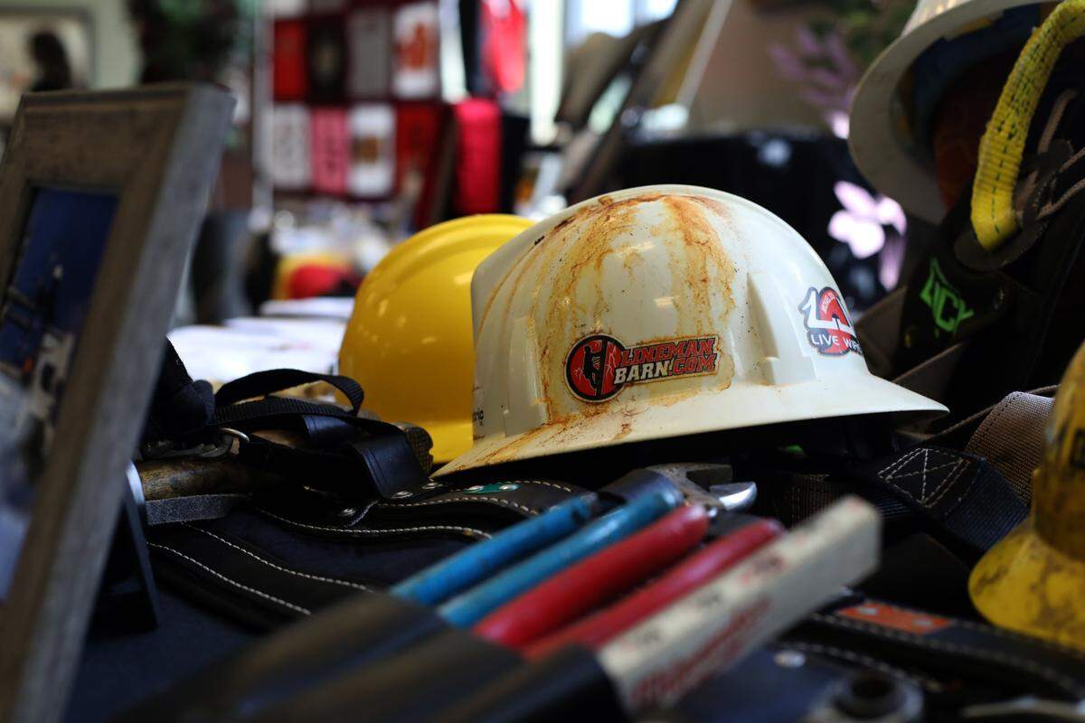 Guests viewed a table filled with lineman’s gear at the funeral service for Cayce Seal at St. Clare Catholic Church in Waveland on July 1, 2021.