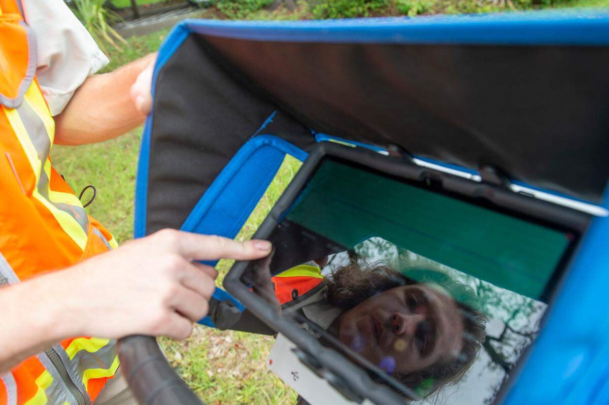 Clayton Fulgham looks at the data from a tree root scan after mapping out the roots on a property in Ocean Springs on Thursday, May 26, 2022.