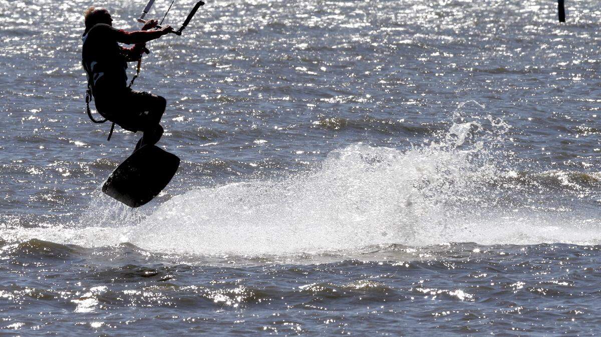 TIM ISBELL/SUN HERALD 
 John Lott takes to the air while kite surfing near Ken Combs Pier in Gulfport, Monday, Oct. 19, 2015. A brisk wind from the southeast created prime kite surfing conditions. Monday, Oct. 19, 2015.