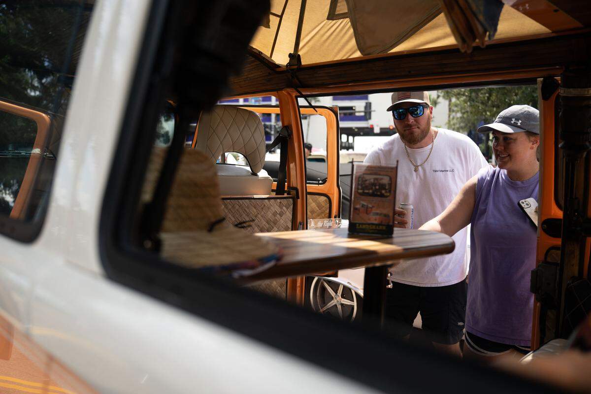 Event attendees check out cars Wednesday at the Biloxi Block Party.