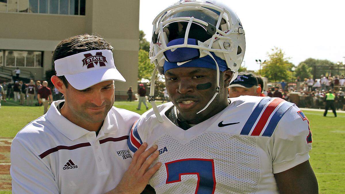 Mississippi State defensive coordinator Manny Diaz, left speaks with Louisiana Tech safety Xavier Woods (7) after their NCAA college football game in Starkville, Miss., Saturday, Oct. 17, 2015. (AP Photo/Jim Lytle)