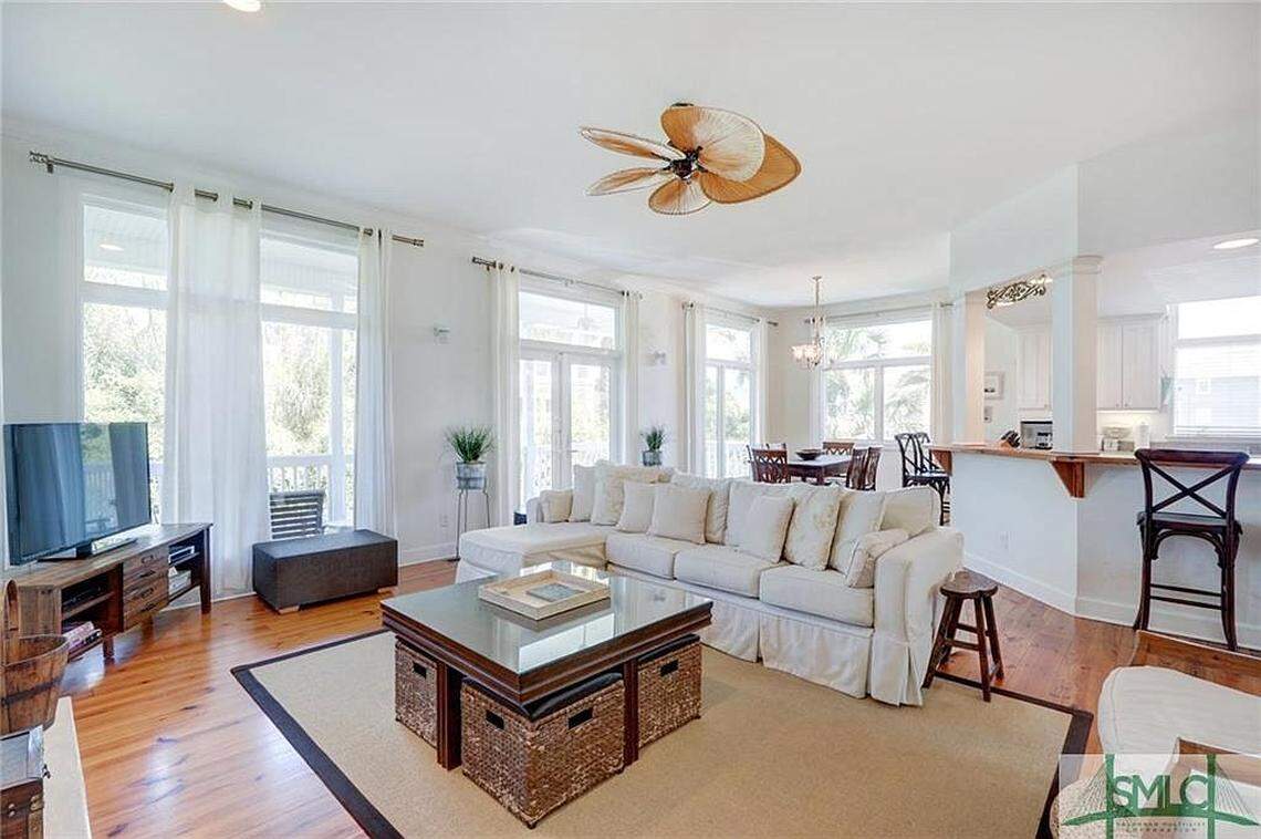 The guest house includes a living room, along with three additional bedrooms and three bathrooms.