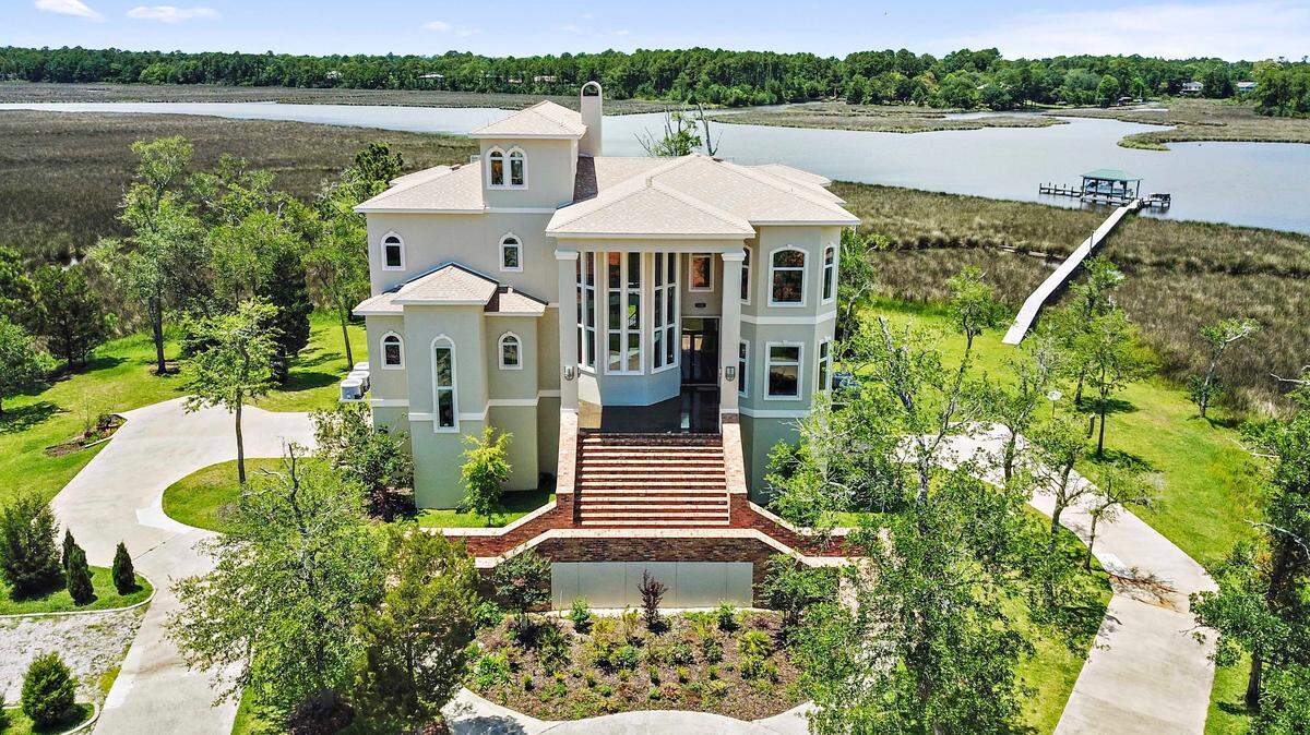 This contemporary chateau-style home on Old Fort Bayou in Ocean Springs will go up for sale by auction on Sept. 9.