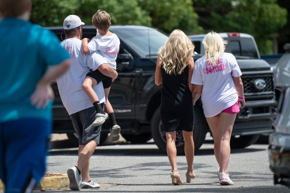 Heather Wyatt leaves Jackson County Chancery Court on Thursday with her son Ryker, center, Ryker’s father Dexter Woods, left, and Ryker’s stepmother Kelly, right.