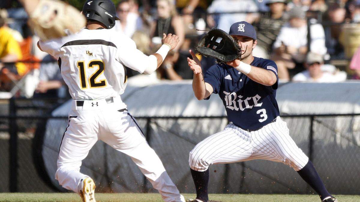 TIM ISBELL/SUN HERALD 
 Southern Miss runner Jake Sandlin is safe at first as Rice's Connor Teykl waits on the throw, Saturday, Apr. 23, 2016.
