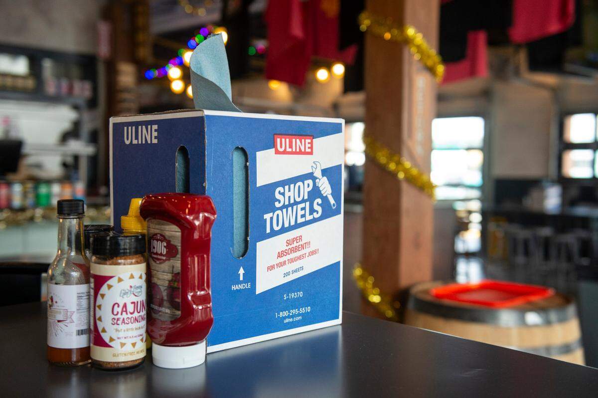 Shop towels serve as napkins at The Garage at Cash Alley, a new restaurant in Ocean Springs that draws inspiration from 1970’s gas stations and restaurants, on Friday, Dec. 13, 2024.