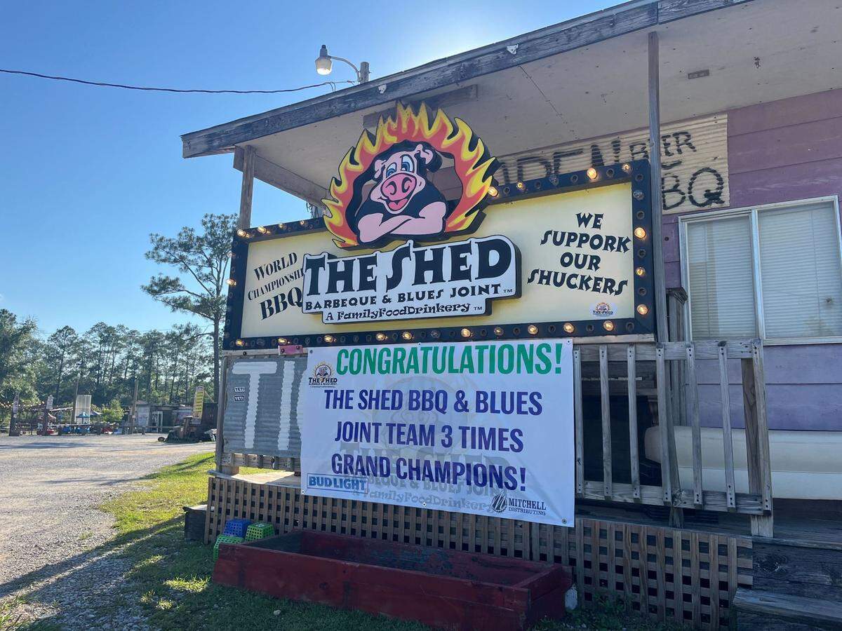 A sign congratulating The Shed’s grand champion team can be seen at the restaurant’s entrance.
