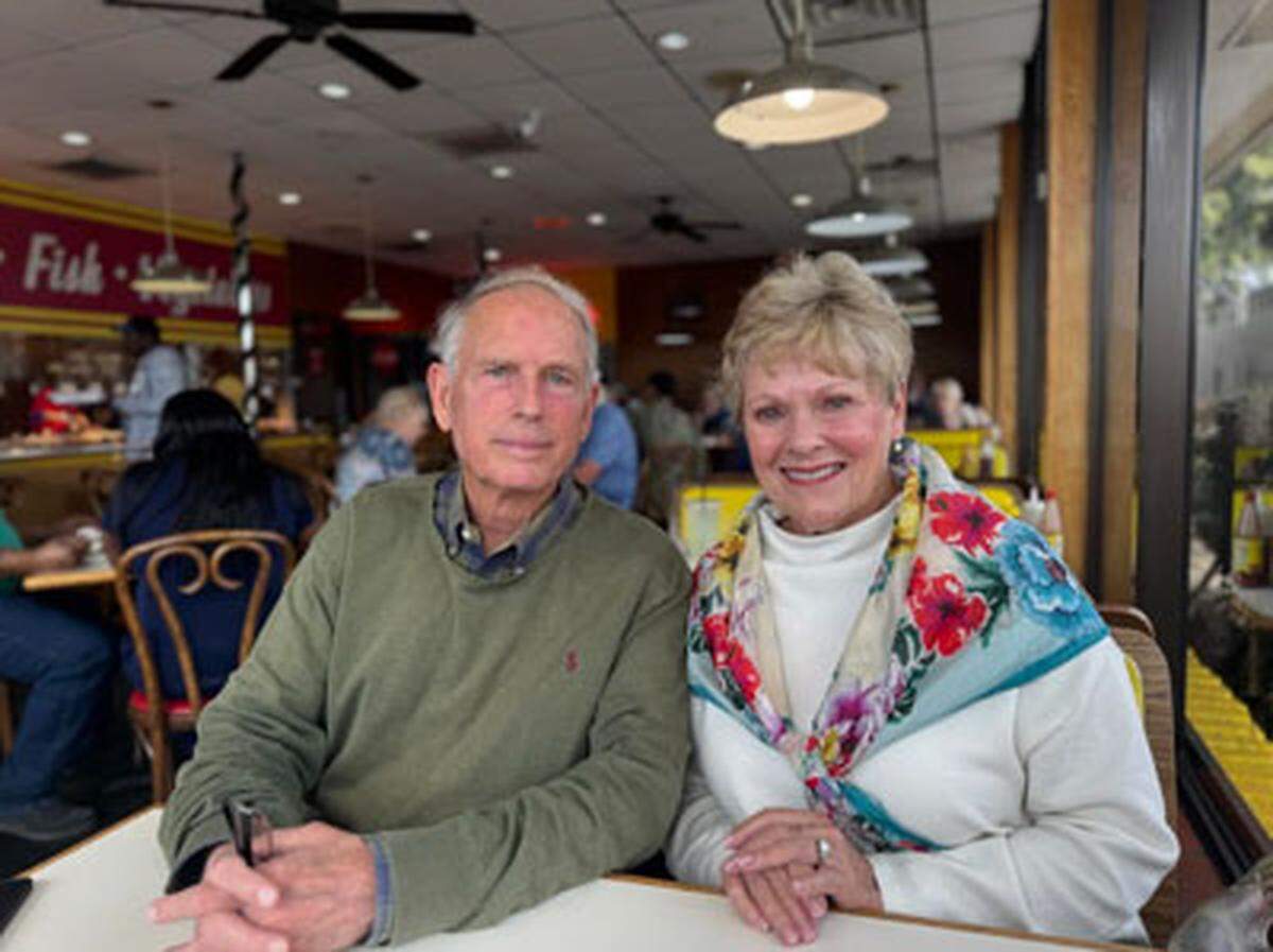 Tom and Patricia Harvey sit inside of their restaurant, Cajun’s Fabulous Fried Chicken.