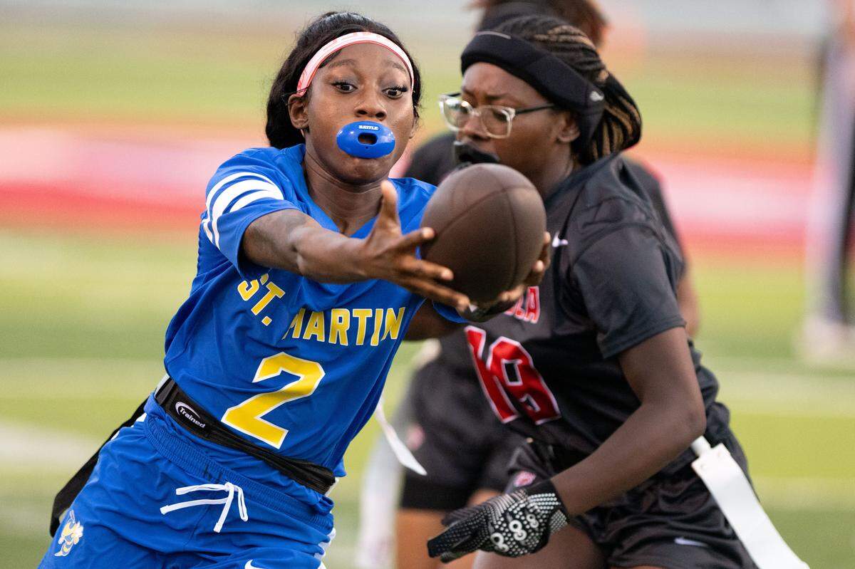 St. Martin’s Dalayzia Mayes (2) reaches out the ball as she attempts to score Thursday during a flag football playoff game at Pascagoula High School.