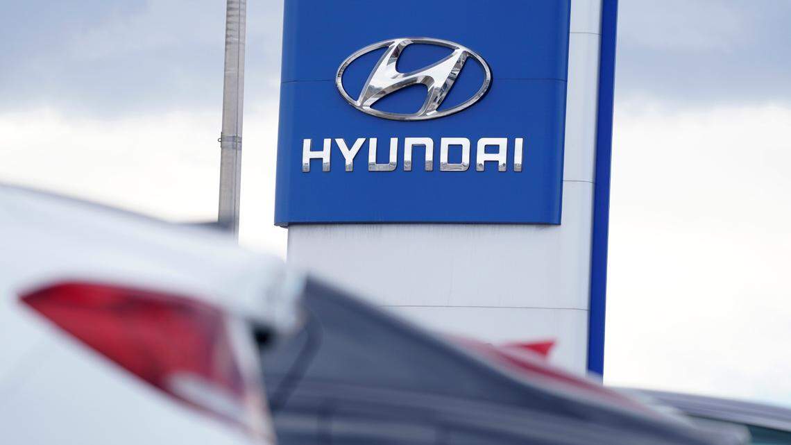 FILE - The company logo hangs over a long row of cars at a Hyundai dealership Sunday, Dec. 20, 2020, in Centennial, Colo. Georgia officials could announce a second massive electric vehicle plant to be built by Hyundai near Savannah in coming days. (AP Photo/David Zalubowski, File)