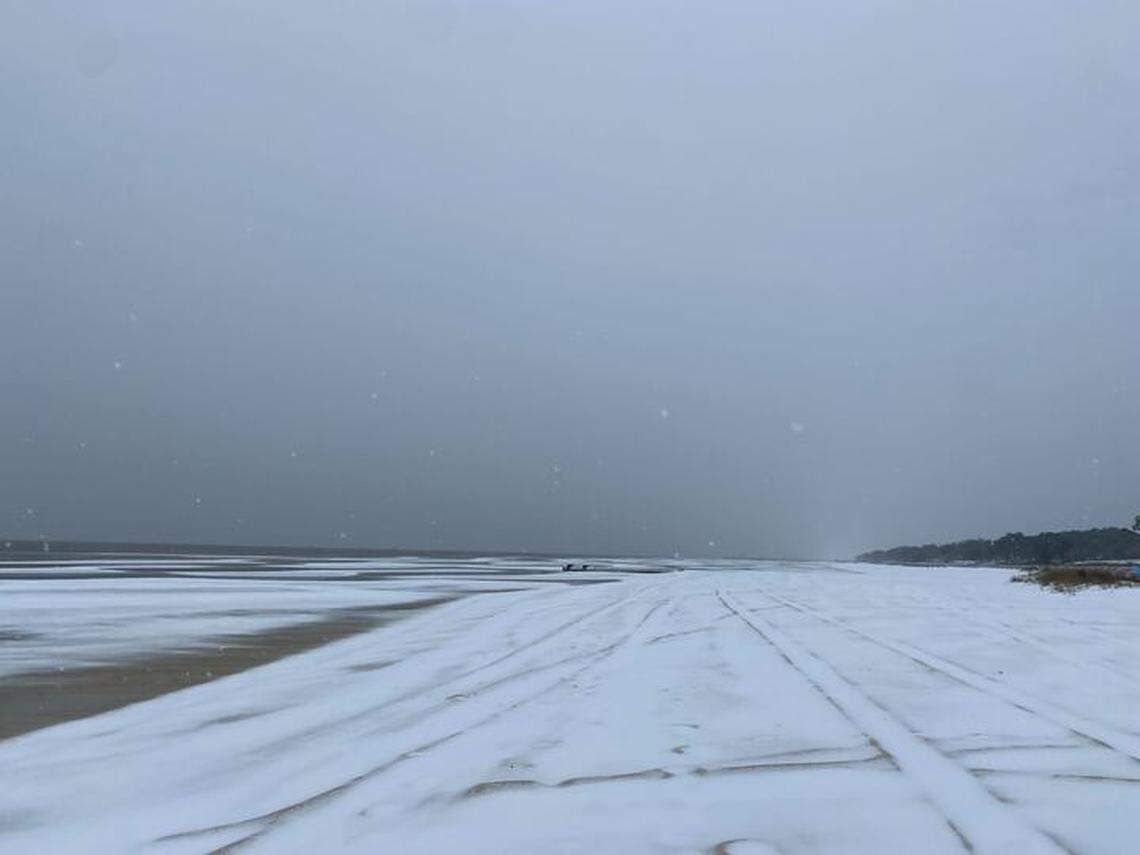Snow fell through strong winds Tuesday, Jan. 21, 2025, on the beach in Pass Christian.